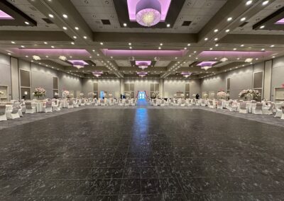 Olathe Conference Center dance floor set up for a wedding with bouquets of flowers at tables