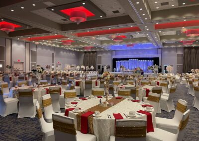 Olathe Conference Center set up for a fancy wedding with many bouquets of flowers