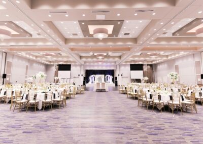 Olathe Conference Center set up for a fancy wedding with large bouquets of flowers